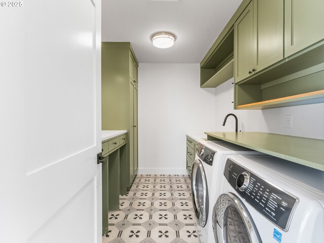 laundry area featuring cabinets and washer and clothes dryer