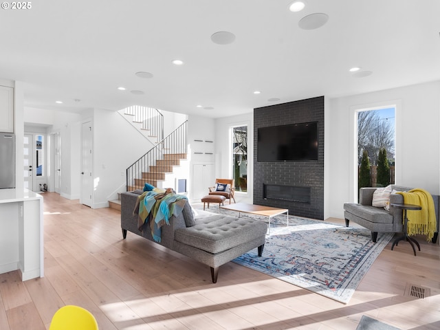 living room with a fireplace and light hardwood / wood-style flooring