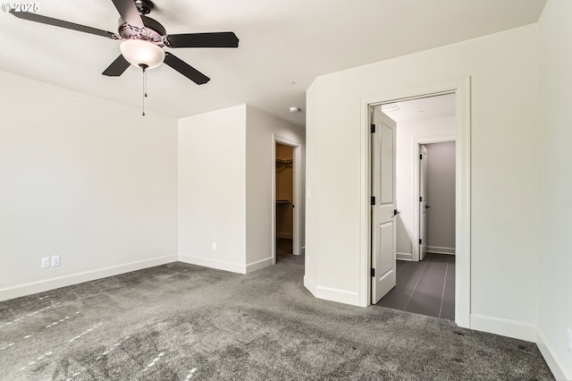 spare room with baseboards, a ceiling fan, and carpet floors