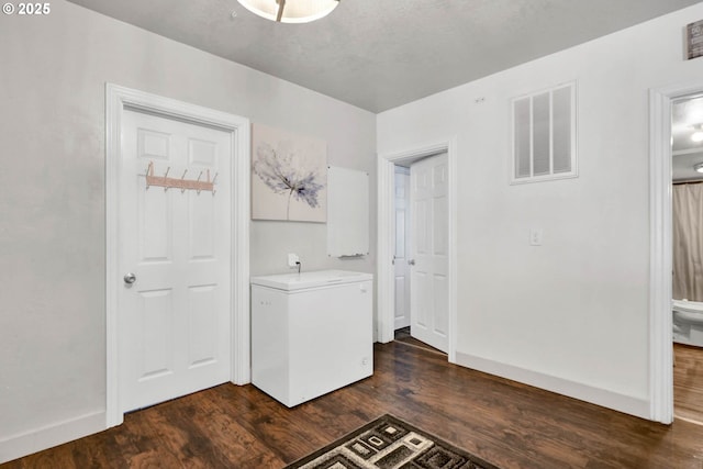 clothes washing area featuring dark hardwood / wood-style flooring