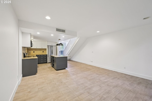 668 Mcvey Ave Unit 83, Lake Oswego, OR 97034 - kitchen with stainless steel appliances, white cabinetry, a kitchen island, light wood-type flooring, and recessed lighting