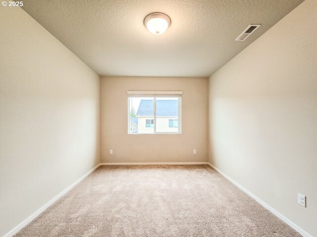 16156 NW Pristine Ln, Portland, OR 97229 - spare room featuring carpet flooring, a textured ceiling, and baseboards