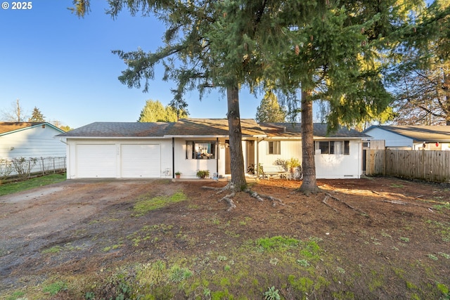 ranch-style house with an attached garage, driveway, and fence