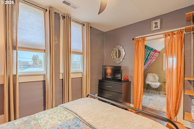 bedroom featuring ceiling fan and visible vents