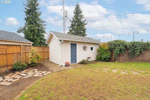 view of yard featuring a fenced backyard and an outbuilding