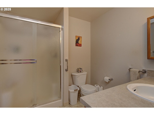 bathroom with toilet, a shower stall, and vanity
