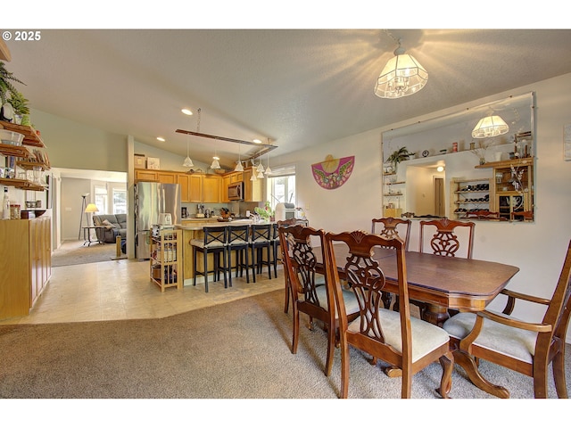 dining space featuring recessed lighting, light colored carpet, and lofted ceiling