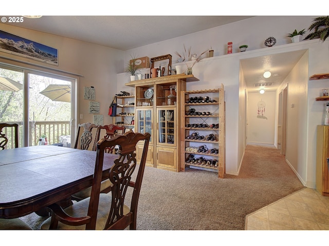 dining area with light colored carpet, baseboards, and visible vents