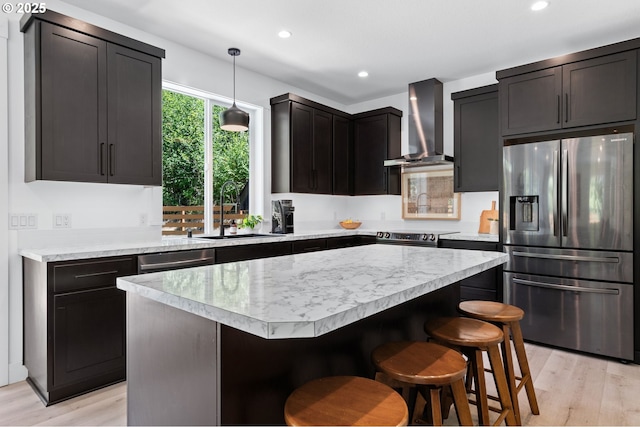 28009 NE Thompson Cir, Yacolt, WA 98675 - kitchen featuring stainless steel appliances, wall chimney exhaust hood, light countertops, light wood-style floors, and recessed lighting