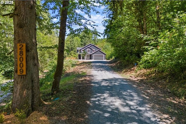 28009 NE Thompson Cir, Yacolt, WA 98675 - view of front facade featuring gravel driveway and a garage