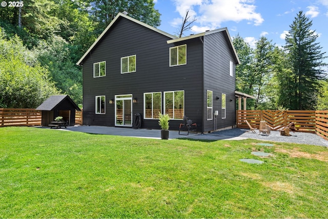 28009 NE Thompson Cir, Yacolt, WA 98675 - rear view of property featuring a patio, a fenced backyard, and a storage unit