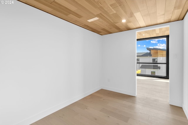 spare room featuring wooden ceiling, recessed lighting, wood finished floors, and baseboards