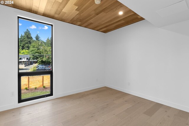 unfurnished room featuring recessed lighting, wooden ceiling, baseboards, and light wood-style floors