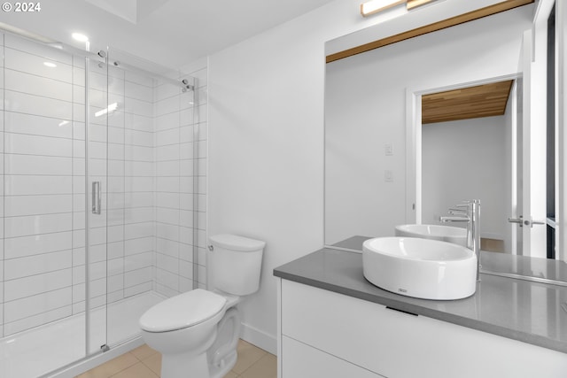 full bath with vanity, tile patterned floors, toilet, and a stall shower