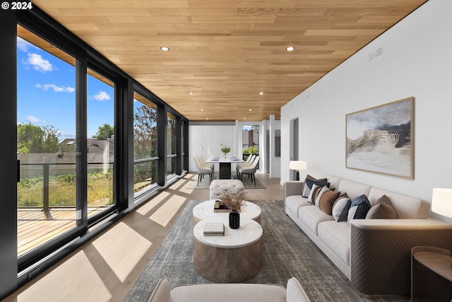 sunroom / solarium featuring visible vents and wooden ceiling