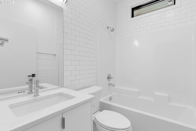 bathroom featuring shower / bathing tub combination, toilet, and vanity