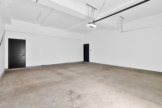 garage with a garage door opener and baseboards