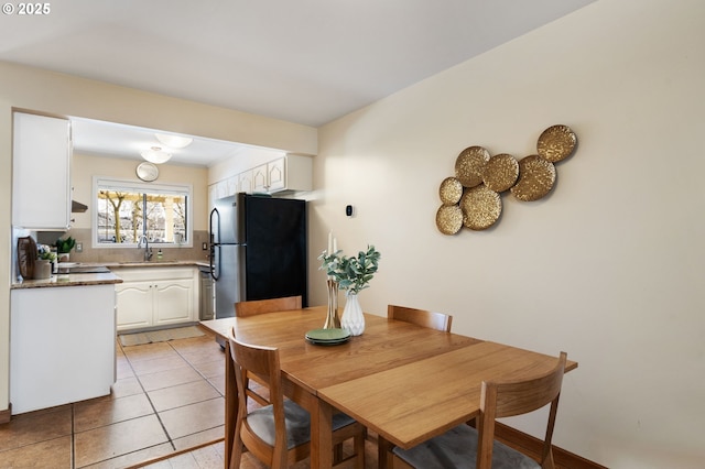 dining space featuring light tile patterned floors