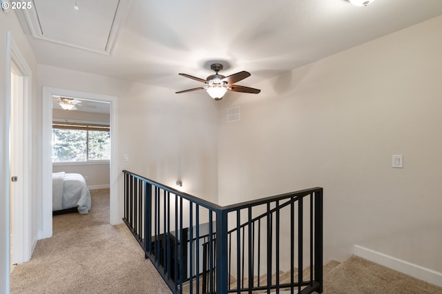 stairway with a ceiling fan, carpet, visible vents, and baseboards