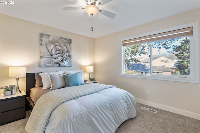 bedroom featuring light carpet, visible vents, a ceiling fan, and baseboards