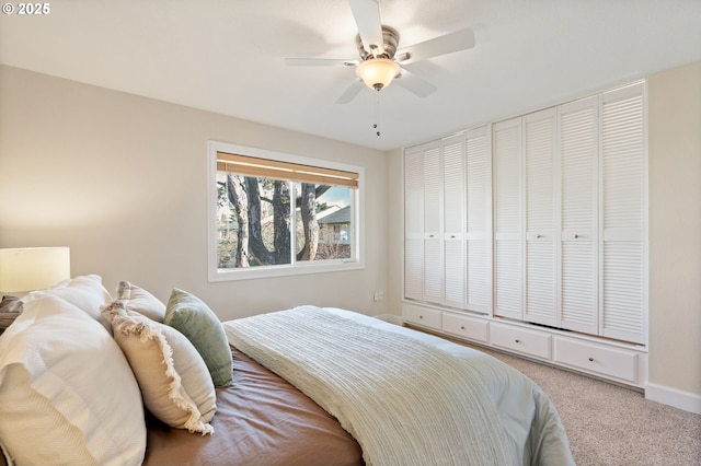 bedroom featuring ceiling fan, baseboards, and carpet