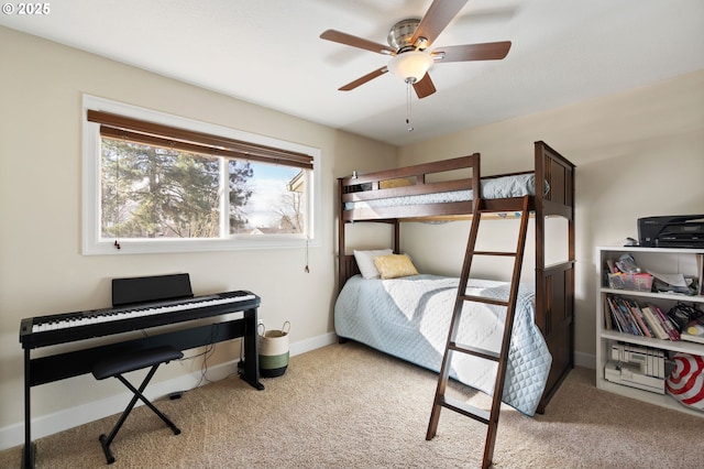 carpeted bedroom with baseboards and a ceiling fan