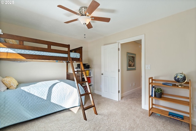 bedroom with a ceiling fan, baseboards, and light carpet