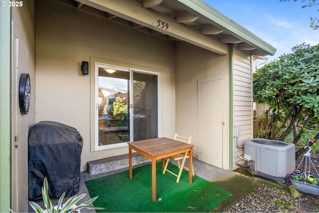 view of patio with central AC and a grill