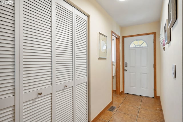 entryway featuring light tile patterned floors, baseboards, and visible vents