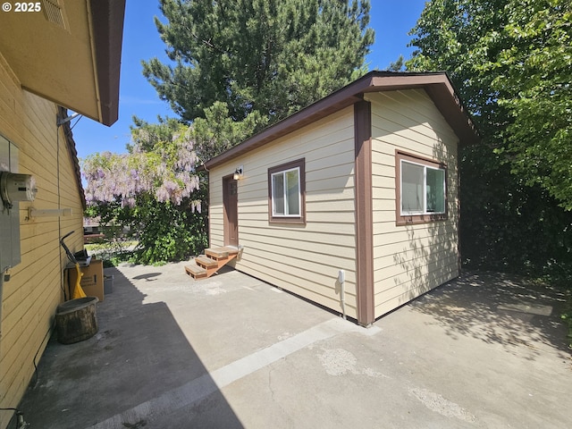 view of side of home with entry steps and a patio