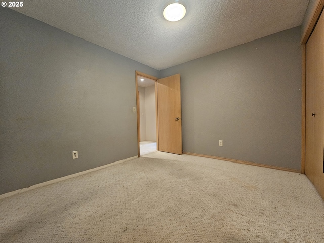 710 E Quince Ave, Hermiston, OR 97838 - unfurnished bedroom with carpet flooring, a closet, a textured ceiling, and baseboards