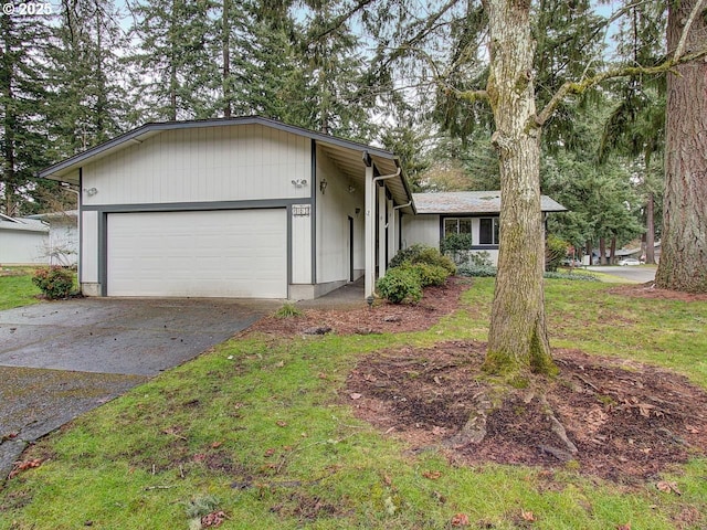 single story home with a garage and a front lawn