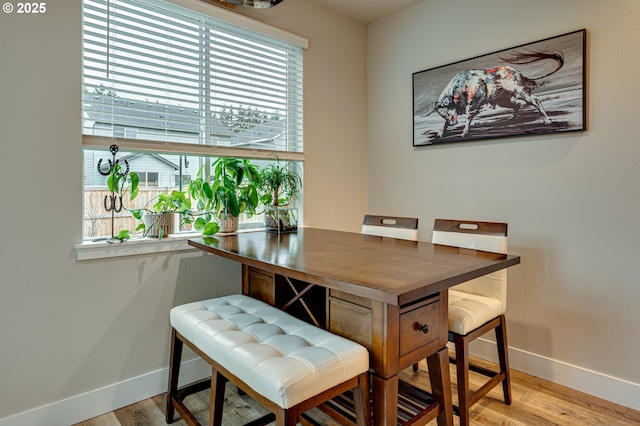 dining room featuring baseboards and wood finished floors