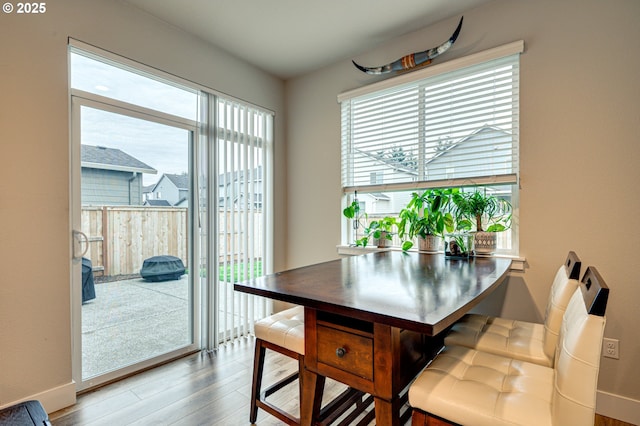 dining room featuring baseboards and wood finished floors