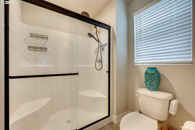 bathroom with toilet and a stall shower