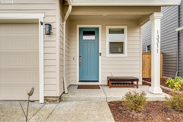 property entrance featuring a garage and fence