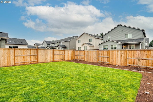 view of yard featuring a residential view and a fenced backyard