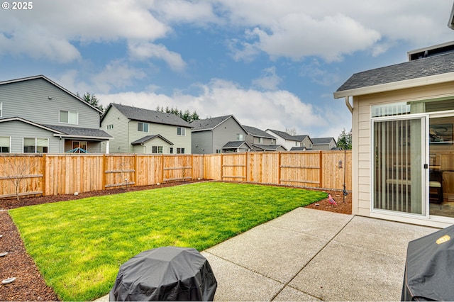 view of yard with a patio area, a residential view, and a fenced backyard