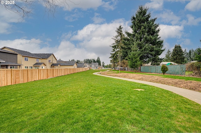 view of yard with a residential view and fence