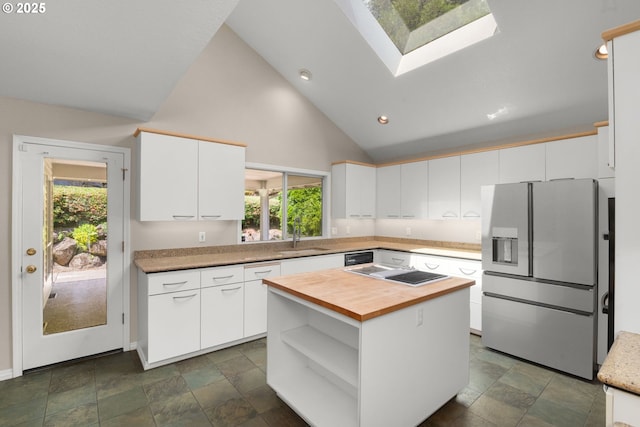 2731 SW 28th Dr, Portland, OR 97219 - kitchen with refrigerator with ice dispenser, butcher block countertops, a skylight, healthy amount of natural light, and high vaulted ceiling
