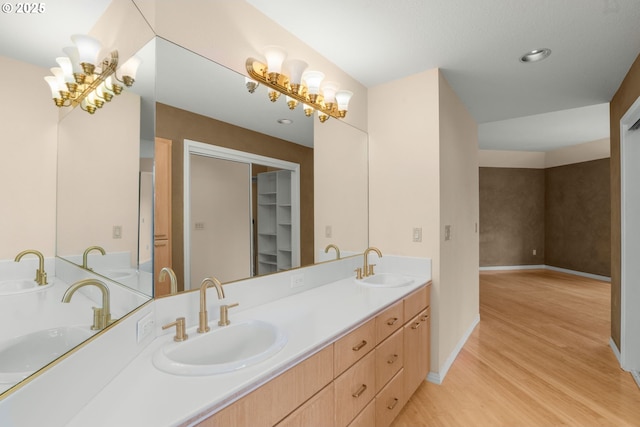 2731 SW 28th Dr, Portland, OR 97219 - bathroom featuring double vanity, wood finished floors, a tub, and a spacious closet