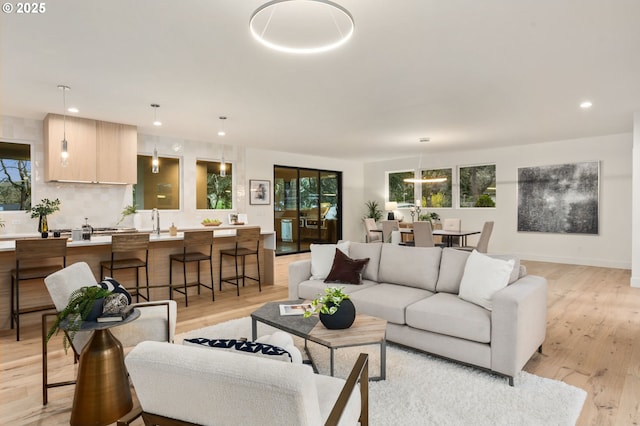 living room with recessed lighting and light wood-style flooring