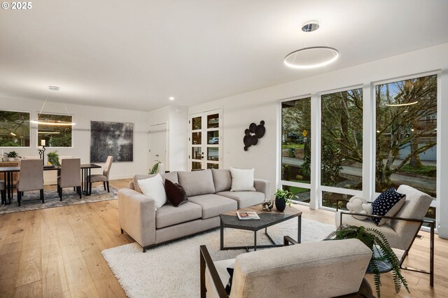 dining space with visible vents, plenty of natural light, baseboards, and hardwood / wood-style floors