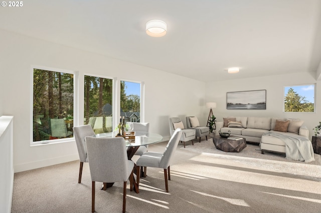 carpeted dining room with baseboards