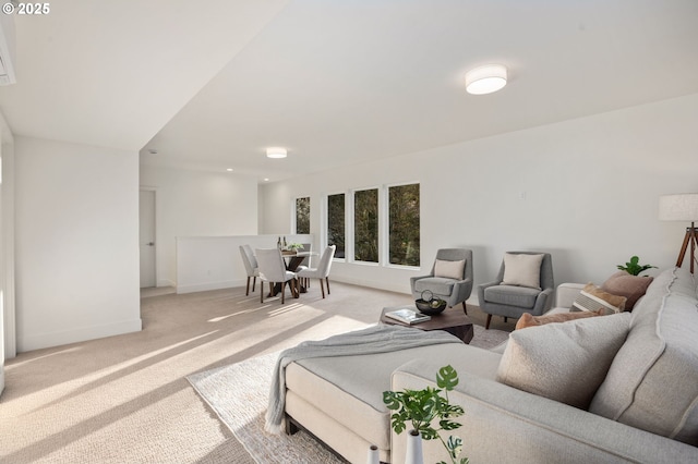 living room featuring light carpet and baseboards