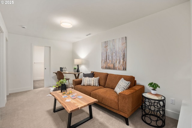 living room featuring light colored carpet, visible vents, and baseboards