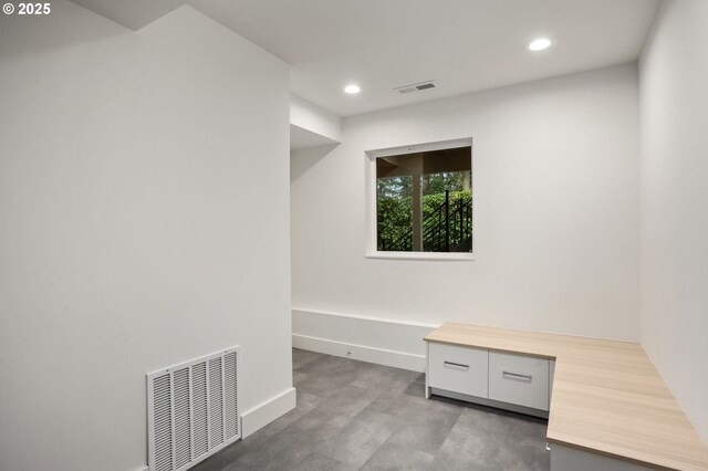 unfurnished room with visible vents, light colored carpet, and baseboards