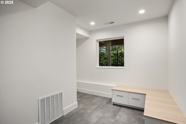 unfurnished office featuring recessed lighting, visible vents, baseboards, and concrete flooring