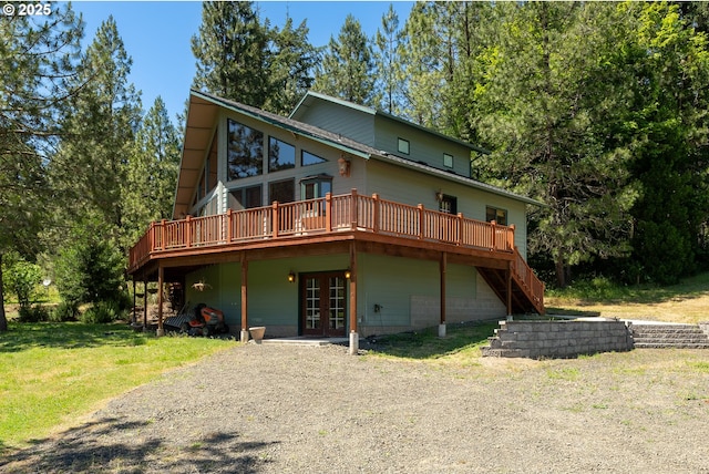 back of property with stairs, a yard, french doors, and a wooden deck