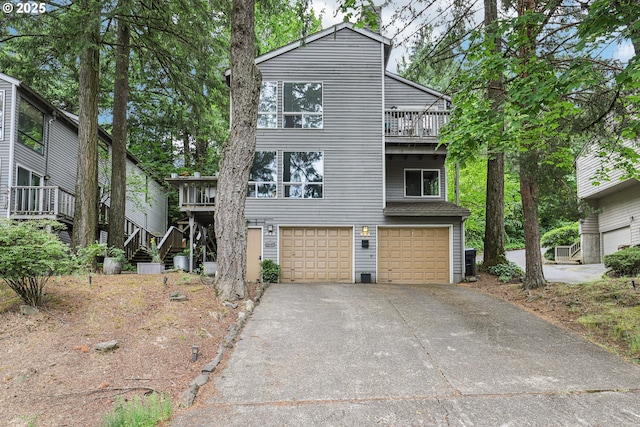 243 Cervantes, Lake Oswego, OR 97035 - view of front of house featuring an attached garage, driveway, stairway, and a balcony